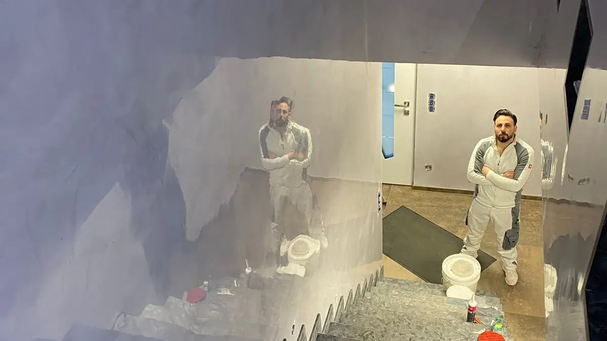 Treppenhaus während der Ausführung, Handwerker vor frisch gespachtelten Wänden